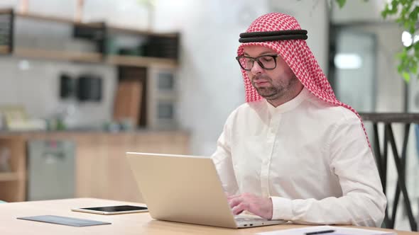 Young Arab Businessman Working on Laptop in Office