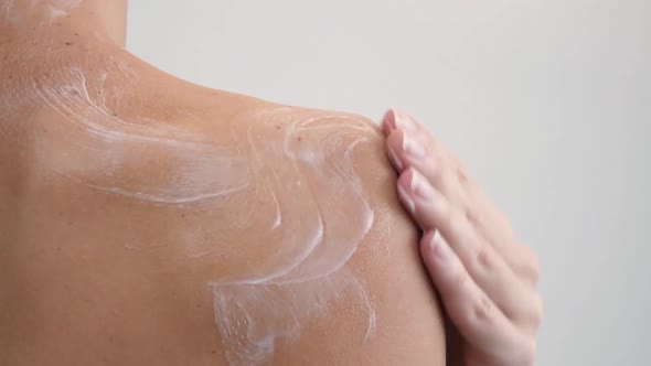 Shoulder and Woman Back Body Lotion Spreading Slow Motion Closeup