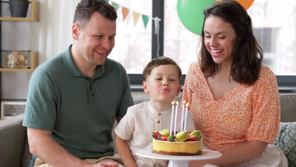 Happy Family with Birthday Cake at Home