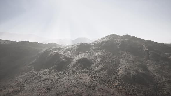 Sun Rays Over Mountains in a Valley