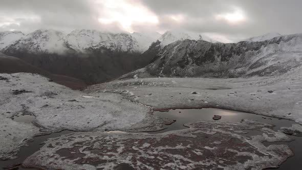 Amazing Aerial Flight Over Foggy Mountains Range Meadows and Snowcapped Peaks in Winter Time