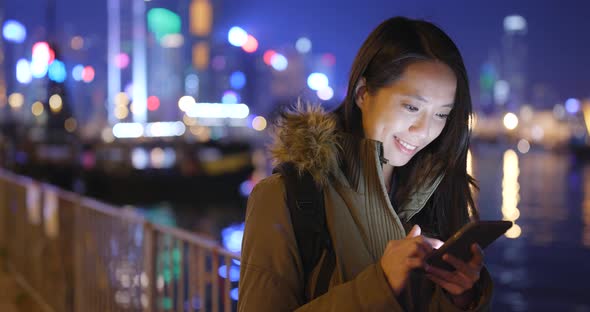 Young Woman Use of Smart Phone in City at Night