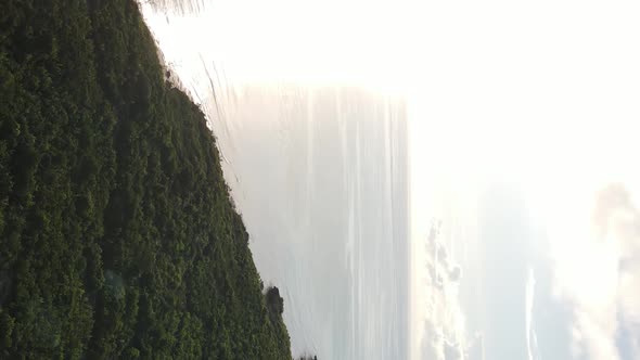 Vertical Video of the Ocean Near the Coast of Zanzibar Tanzania Aerial View