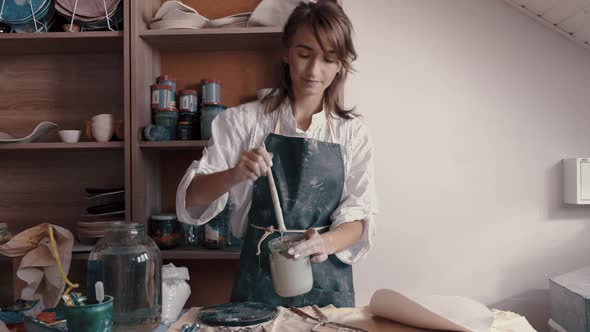 Professional Potter Mixing Paint and Glaze