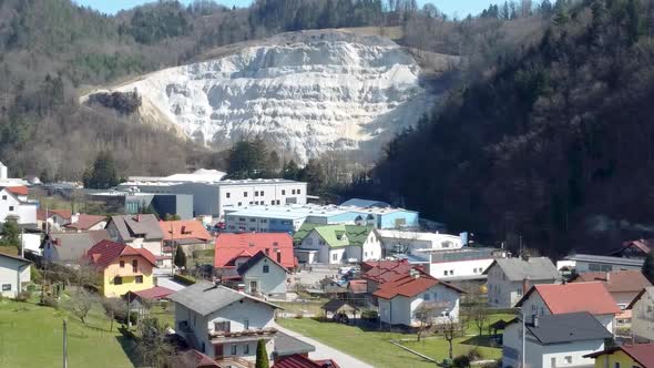 Traditional Slovenian Village and Steep Mountain Background, Charming City Escape, Aerial