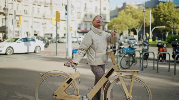 Female Cyclist Admiring City Street