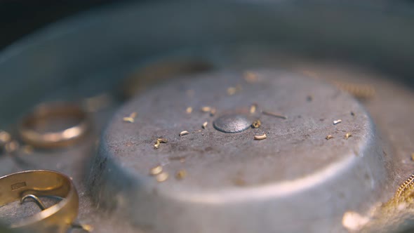 Little Parts of Gold Falls Down Into Metal Box Close View