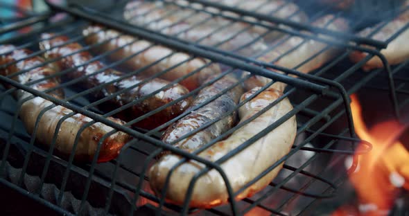 Sausages Are Fried on an Open Fire, Close Up Slow Motion