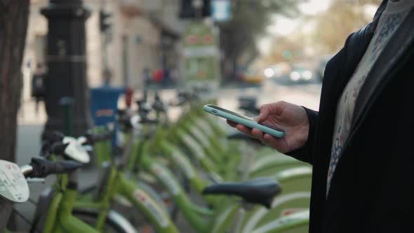 Female Booking a Public Rental Bicycle on Mobile Application