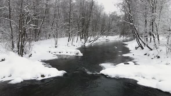 Beautiful Winter Landscape with an Icefree River Aerial View