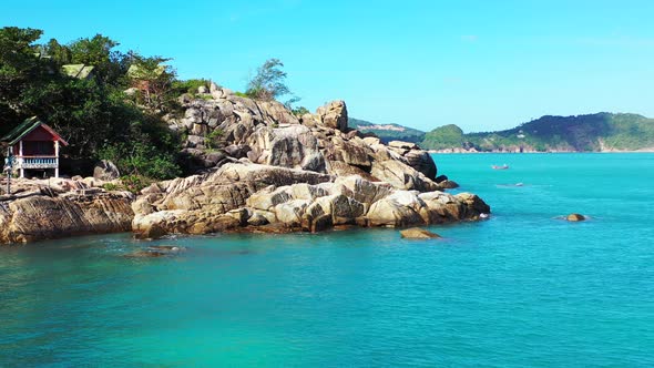 Tropical birds eye copy space shot of a white sand paradise beach and blue sea background in 4K