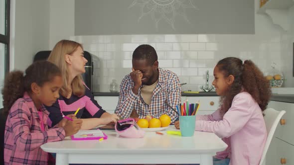 Happy Family with Girls Enjoying Leisure in Kitchen