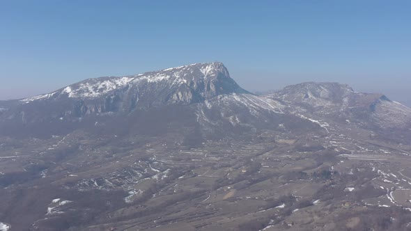 Mountain Stol peak snowed under the blue sky 4K drone video