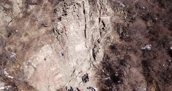 A Group of People are Engaged in Rock Climbing