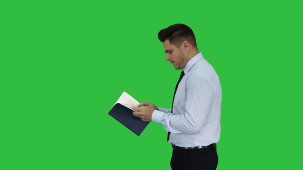 Young confused man trying to read smart book misunderstanding