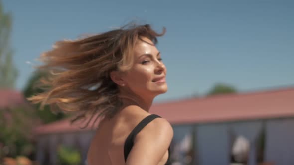 Closeups and Details of Young Woman Wearing Black Swimsuite and Transparent Cape