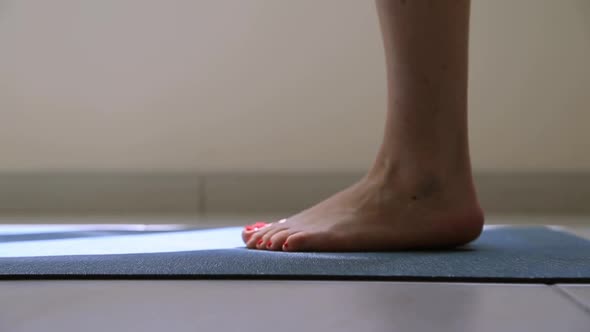 Woman Stretching Her Feet at the Morning Yoga Routine at Home