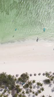 Vertical Video Kitesurfing Near the Shore of Zanzibar Tanzania