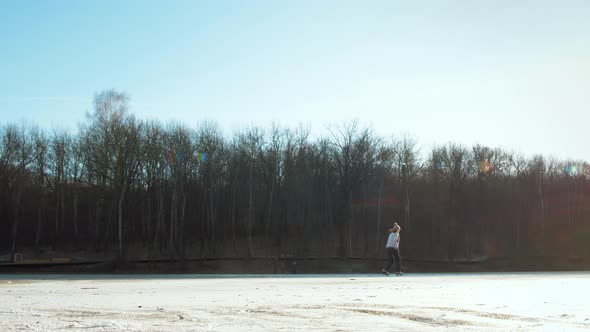 Hockey Player on Frozen Lake Make Ice Sparkles on High Speed Braking