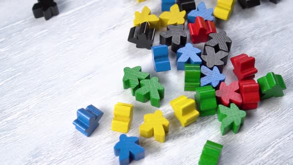 Bright colored wooden toy figures on a plank 