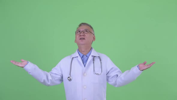 Happy Mature Japanese Man Doctor Catching Something