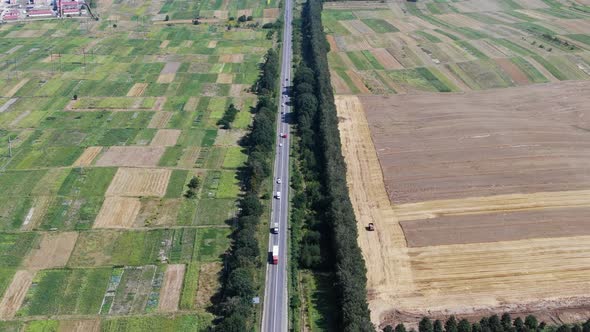 Aerial View of Road With Semi-Trucks in Rural Farmland in Ukraine