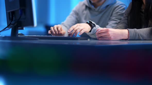 Male Caucasian Hands Typing on Keyboard As Female Palms Lying on Table