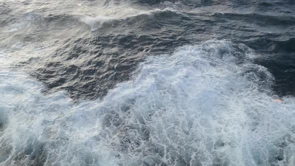 A cruise ship cutting through the sea leaving huge, icy waves in its way