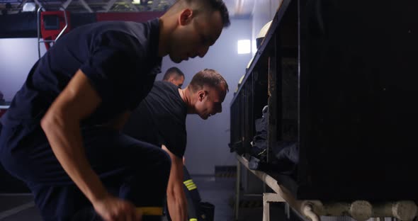 Firefighters Putting on Uniform Near Truck