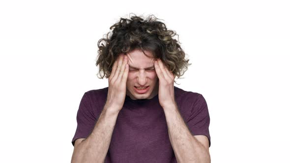 Portrait of Sick Unhappy Man Rubbing Temples and Touching Forehead Because of Headache or