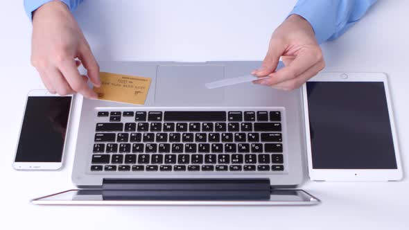 Man Buying with Credit Card, Using Laptop Computer. Close Up