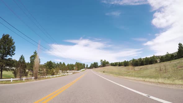 POV-Driving on rural paved road in Colorado.