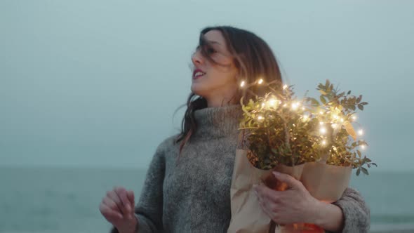 Girl Runs to the Beach with a Cardboard Envelope with Lights