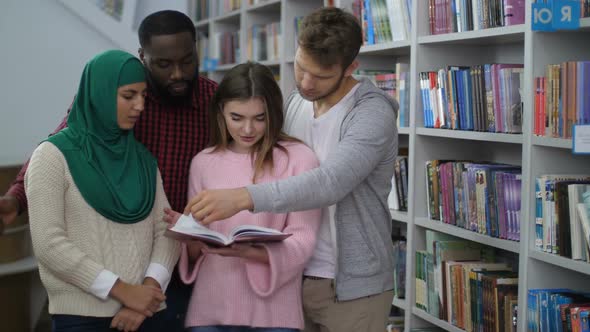 Diverse Students Standing Near Bookshelves