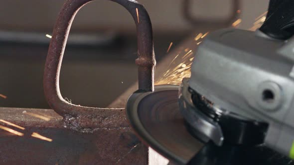 Slow motion of a metal grinder during work with sparks flying