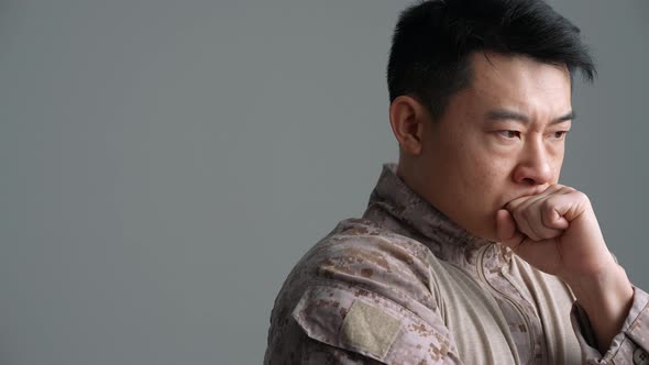 Angry military Asian man thinking about something