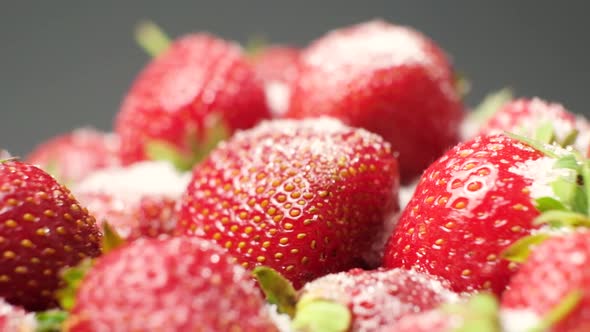 Strawberries Sprinkled with Sugar Spin in a Circle on a Black Background