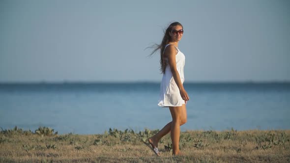 Girl in a White Dress Near the Sea