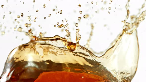 Super Slow Motion Shot of Brown Liquid Splash Isolated on White Background at 1000Fps