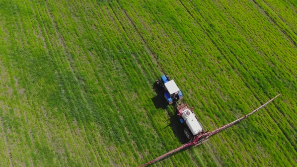 Following Tractor Sprayer in the Field