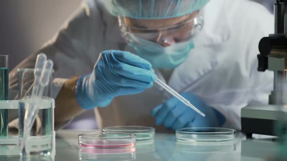 Scientist Carefully Carrying Matured Cell to Another Plate, Conducting Research