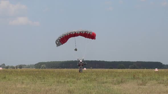 A Parachutist on a Guided Parachute Lands on the Field
