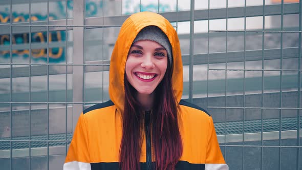 youth, confidence - beautiful hooded woman smiles at the camera