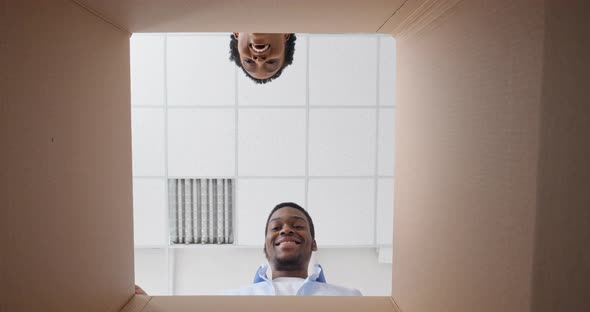 Bottom Portrait Inside View of Cardboard Box African American Couple Black Man and Woman Smile