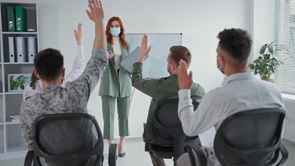 Small Business Young Female Entrepreneur Takes Precautions and Wears Medical Mask During Group