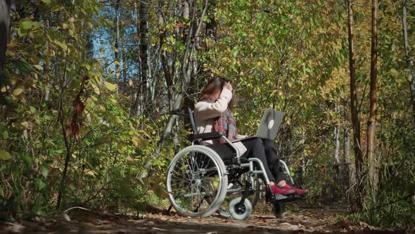 Disabled Woman Using Laptop Outdoors