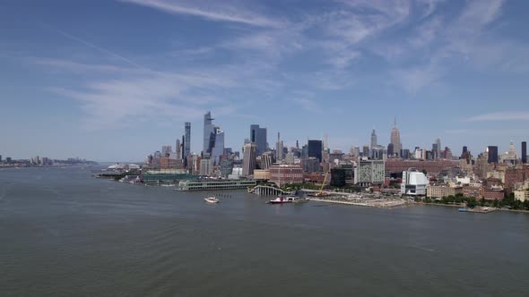 Aerial view over the river, towards the FDNY Marine 1, in sunny New York, USA