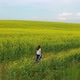 The Girl Runs on a Yellow Flower Field at Sunset  - VideoHive Item for Sale