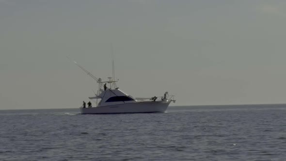 Fishing in the Sea of Cortez near Guaymas Mexico as a dolphin breaches on the bow. Slow motion foota