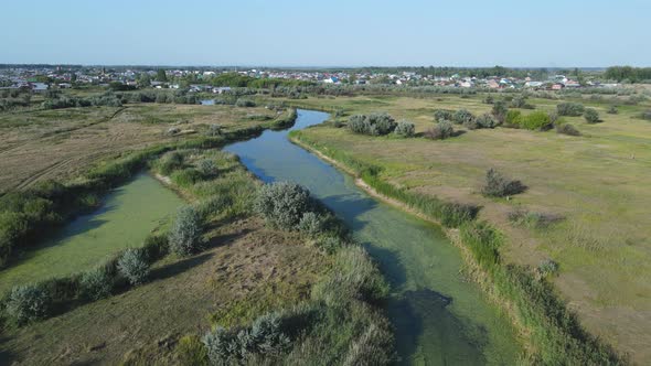 Aerial landscape of a lake surrounded by rural scene shot from a drone.